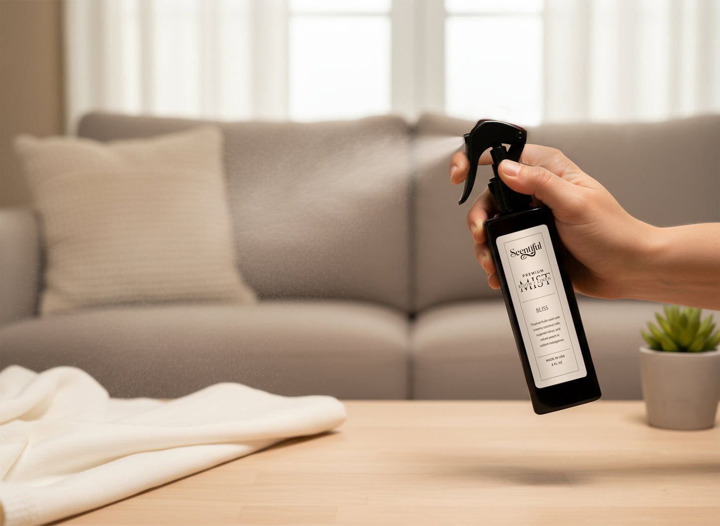 Scentiful room and linen spray being used on a beige couch.