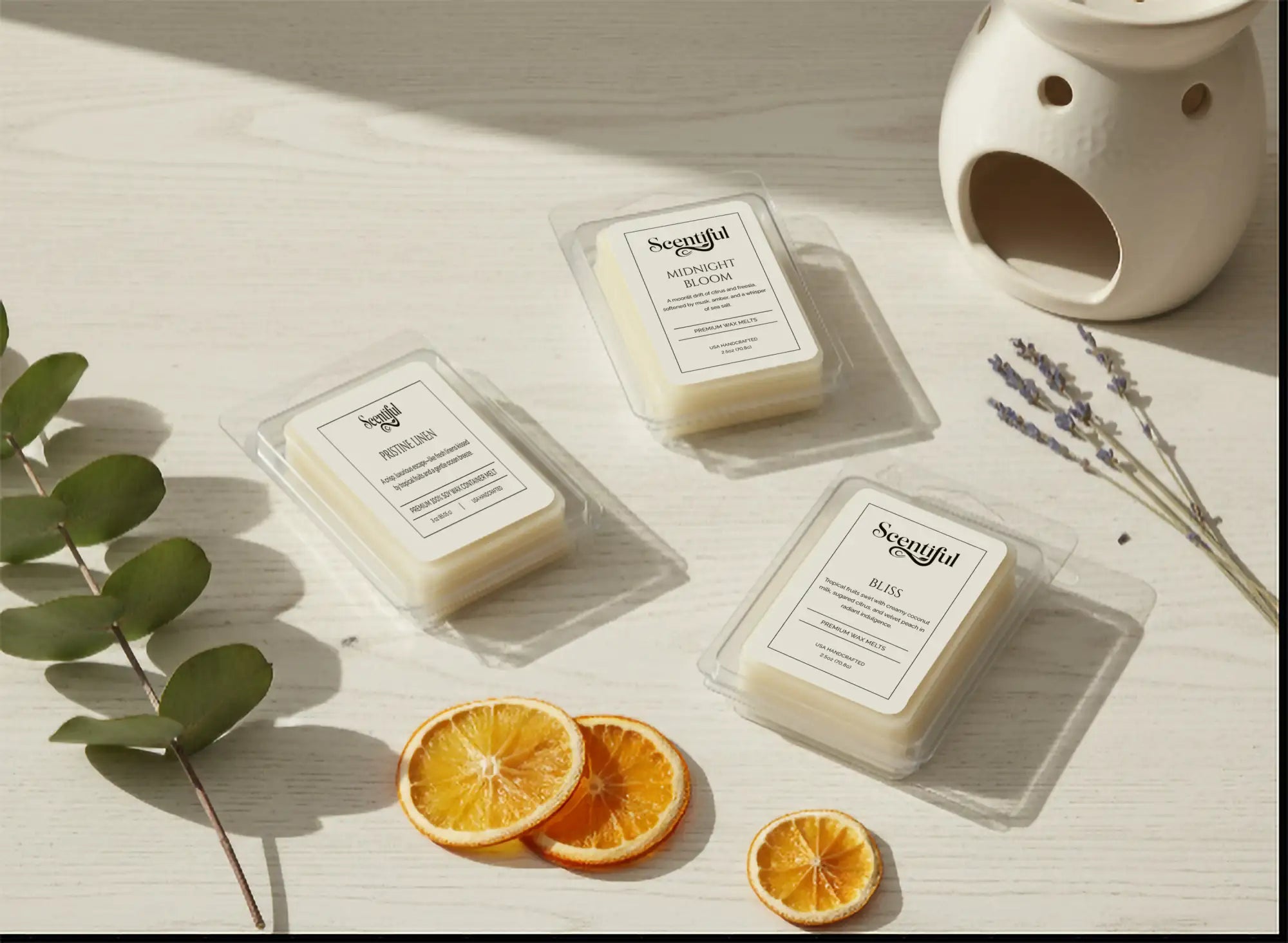Three rectangular white scented wax melts in clear plastic packaging, labeled with the brand ’scentful’ and scent names like “midnight bloom” and “bliss.”